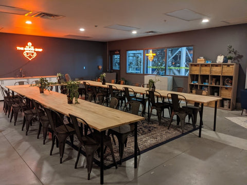 Long wooden table with chairs in a modern office setting.